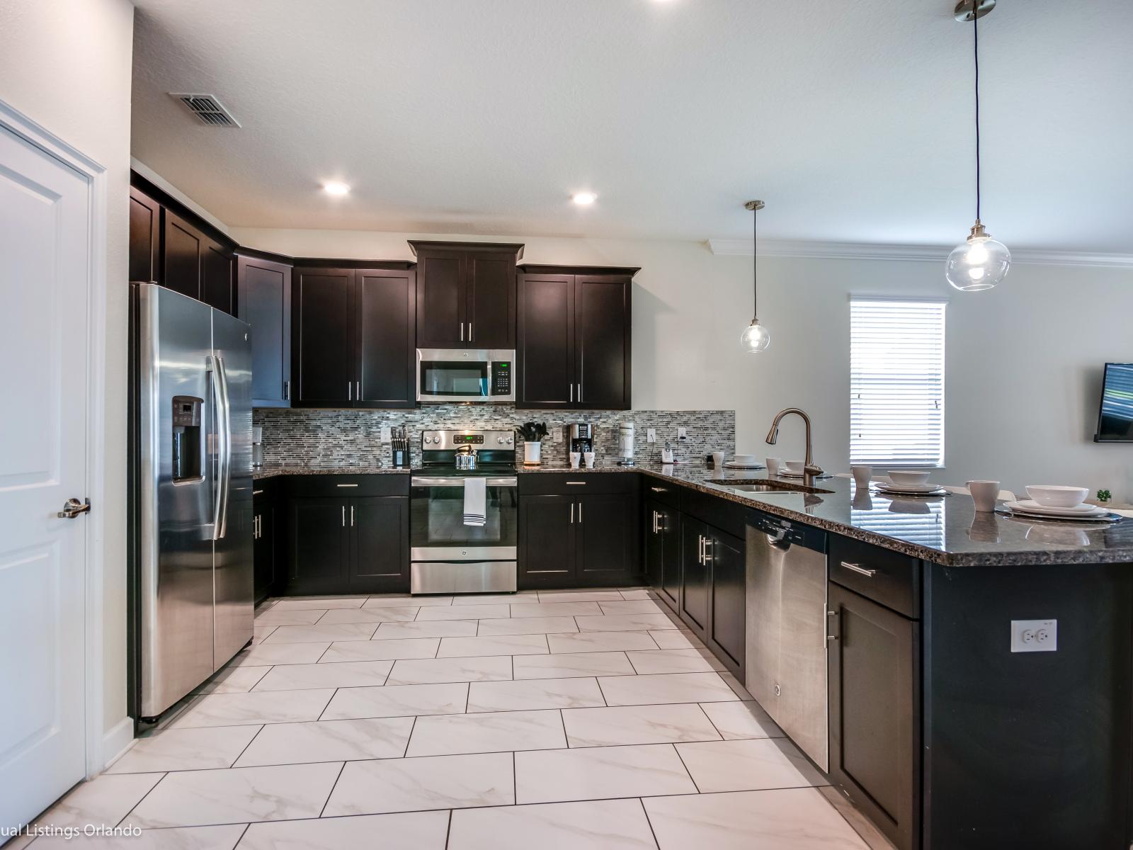 Lush Kitchen of the Home in Davenport Florida - Nothing brings people together like good food  - Elevated cooking experience with high-end, stainless steel appliances - Integrated appliances for modern feel