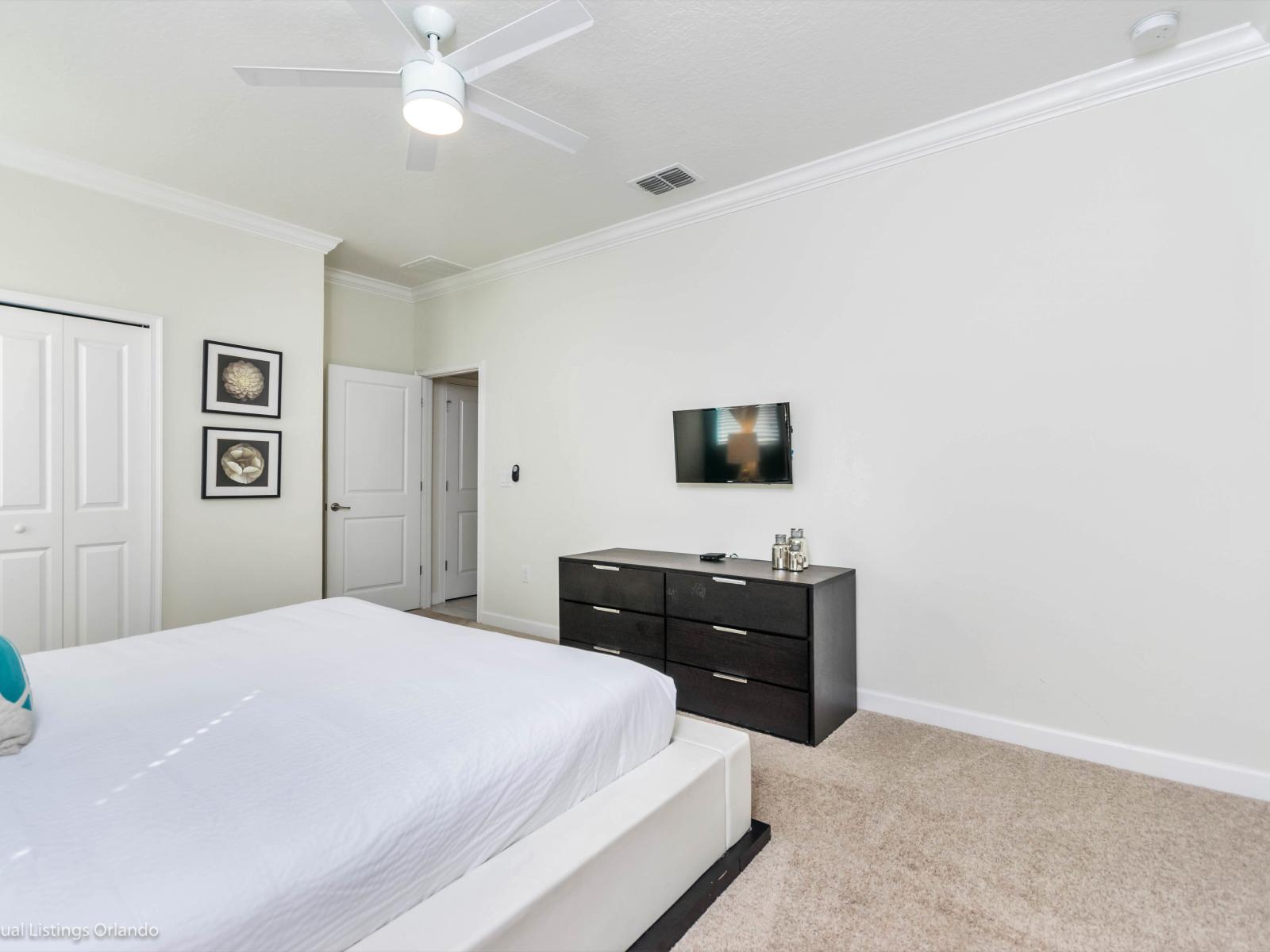 Modern Bedroom of the Home in Davenport Florida - Tranquil retreat designed for rest and relaxation - Comfy bed, soft lighting, and serene ambiance - Offers a peaceful haven to unwind and recharge after a day of adventure - Smart TV and Netflix