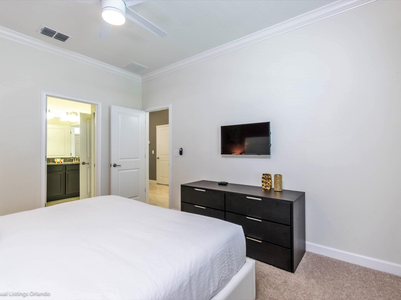 Comfy Bedroom of the Home in Davenport Florida - Smart TV and Netflix - Minimalist decor, creating a clean and uncluttered sleeping space - Cozy retreat with a plush bed, perfect for relaxation