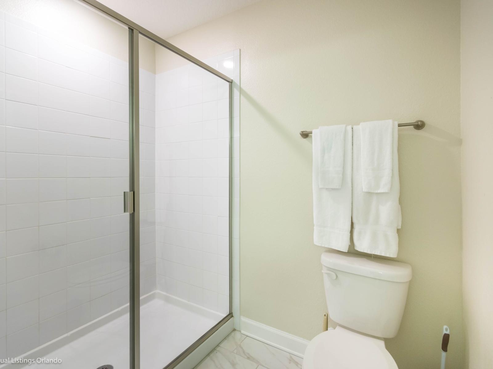 Elegant Bathroom of the Home in Davenport Florida - Retreat designed for relaxation and rejuvenation - Glass-enclosed walk-in shower area