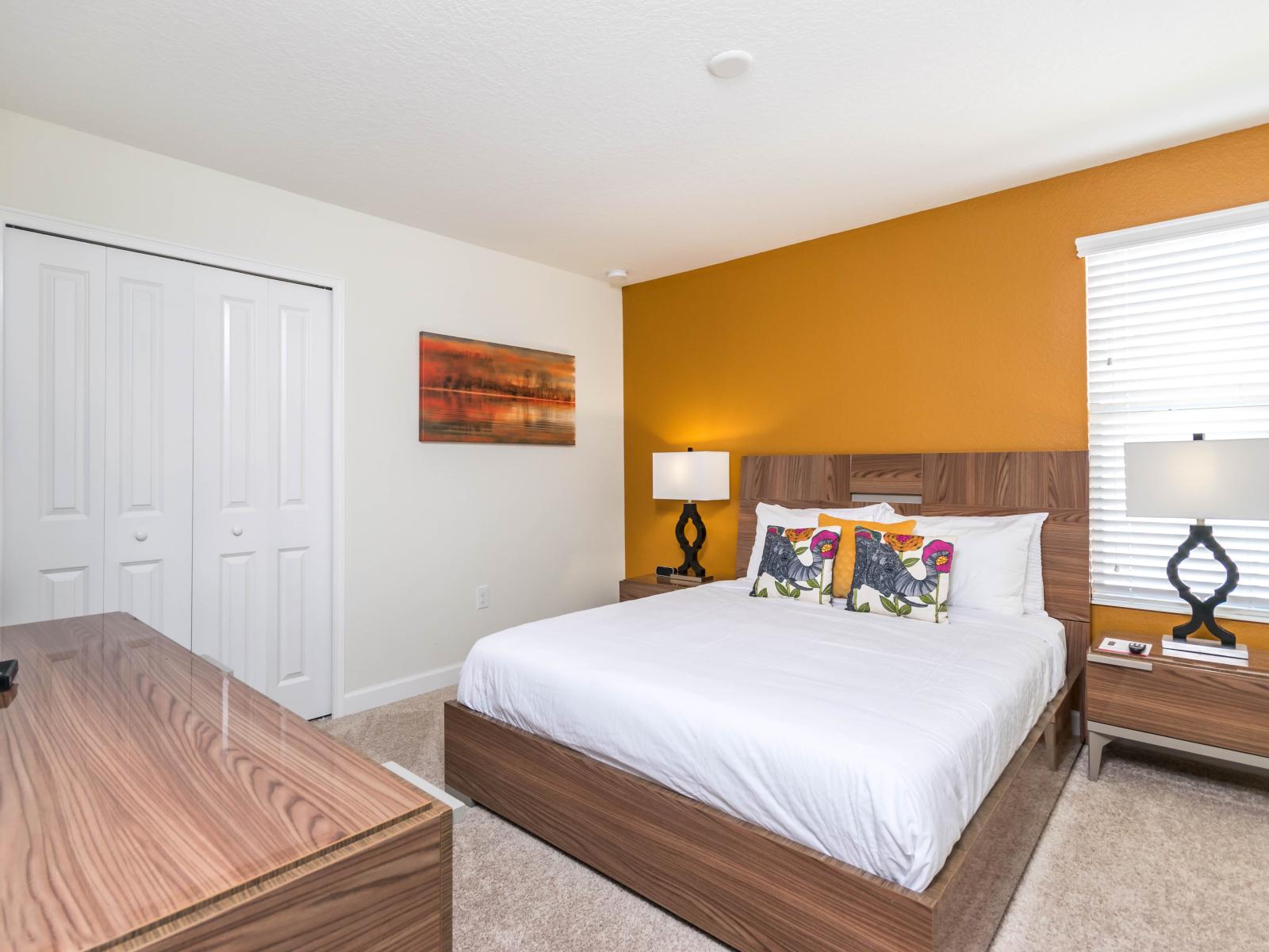 Radiant Bedroom of the Home in Davenport Florida  - The bedroom with a mustard accent wall offers a vibrant retreat  - Smart TV and Netflix - Personalized touches reflecting individual style