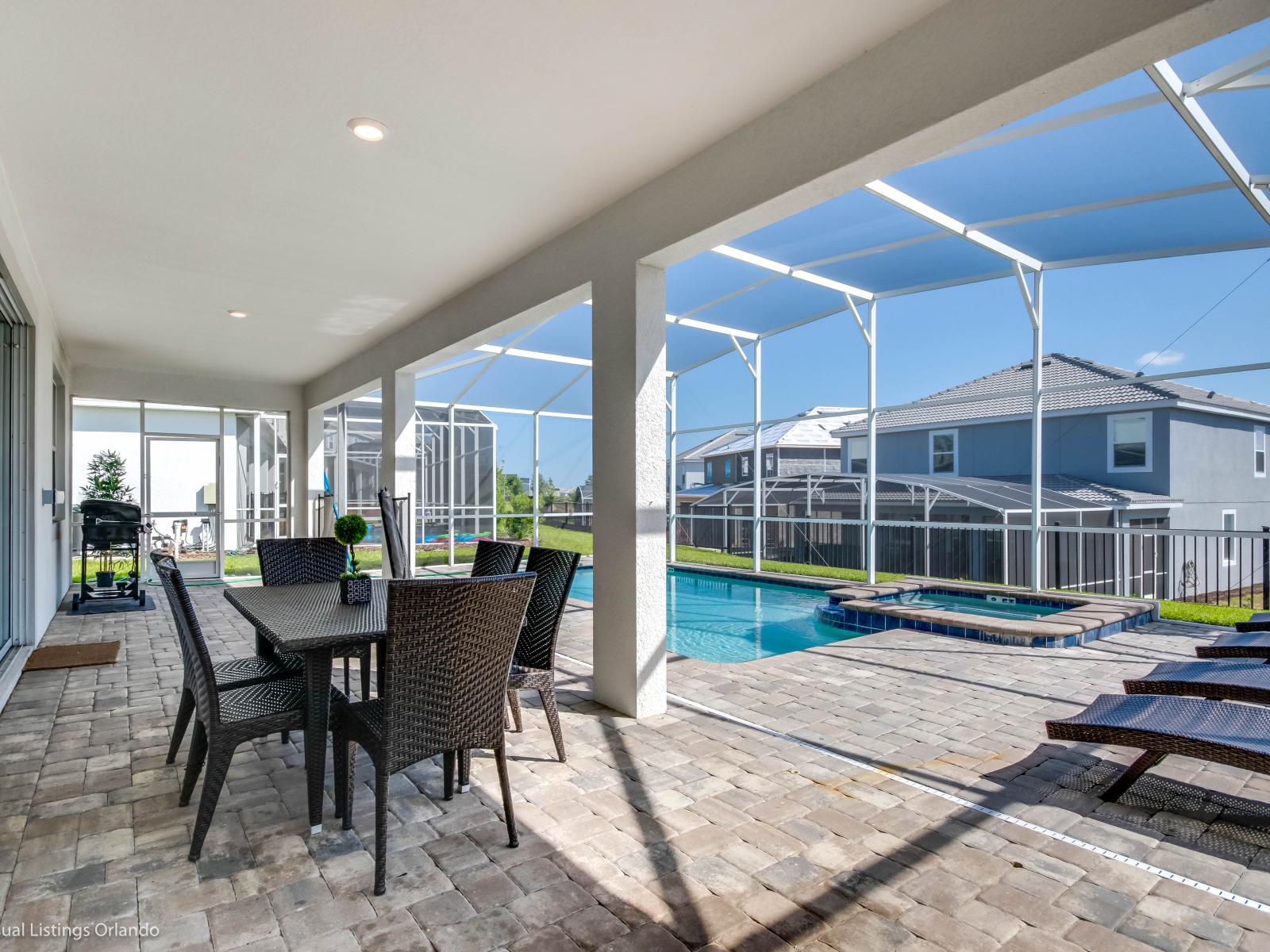 Refreshing Outdoor Dining area of the Home in Davenport Florida - Soak up the Florida sun while relaxing on the comfortable chaise lounge chairs  - Enjoy lunch and evening meals at the outdoor dining area with pool views