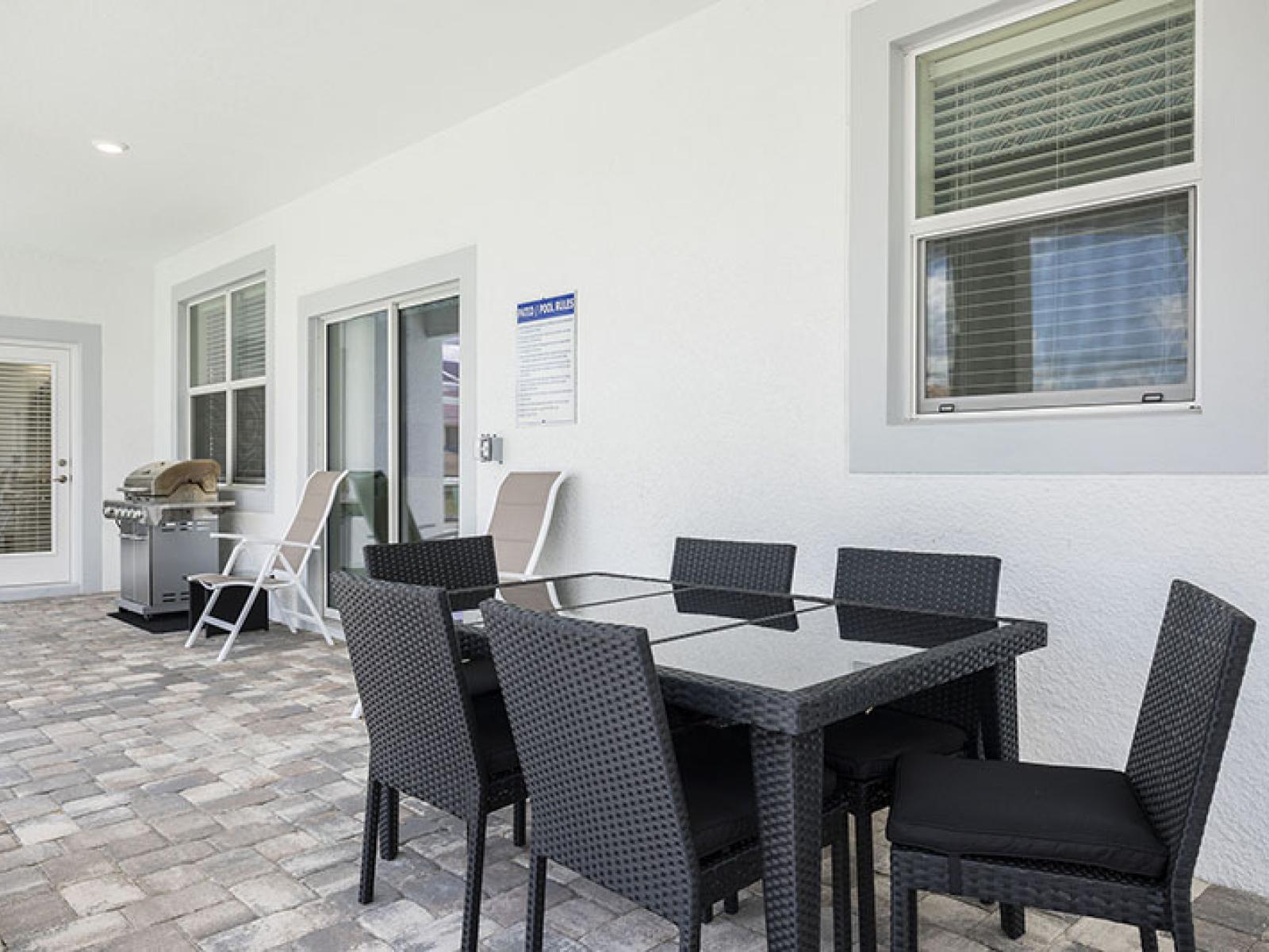 Outdoor Dining Area of the Home in Davenport Florida - Savor the flavors of paradise with a side of poolside serenity - Outdoor dining experience offers a feast for the senses - Every meal accompanied by stunning pool views