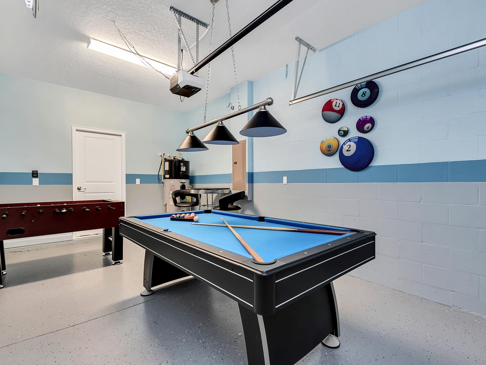 Fun Game Room of the Home in Davenport Florida - Sleek pool table for thrilling matches - Classic foosball table for fast-paced fun - Vibrant space where competition and camaraderie thrive