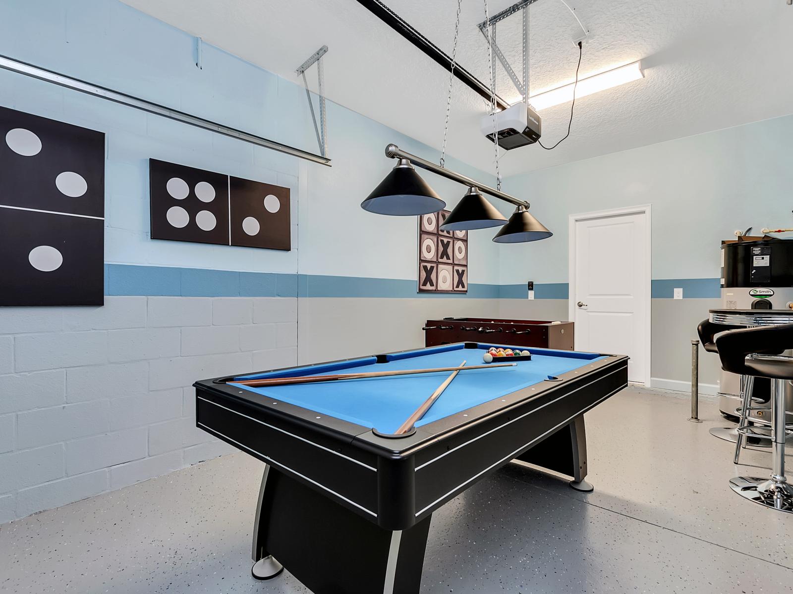 Friendly Game Room of the Home in Davenport Florida - A top-of-the-line pool table for challenging matches - A high-energy foosball table for fast-paced action - A vibrant space where laughter and excitement fill the air