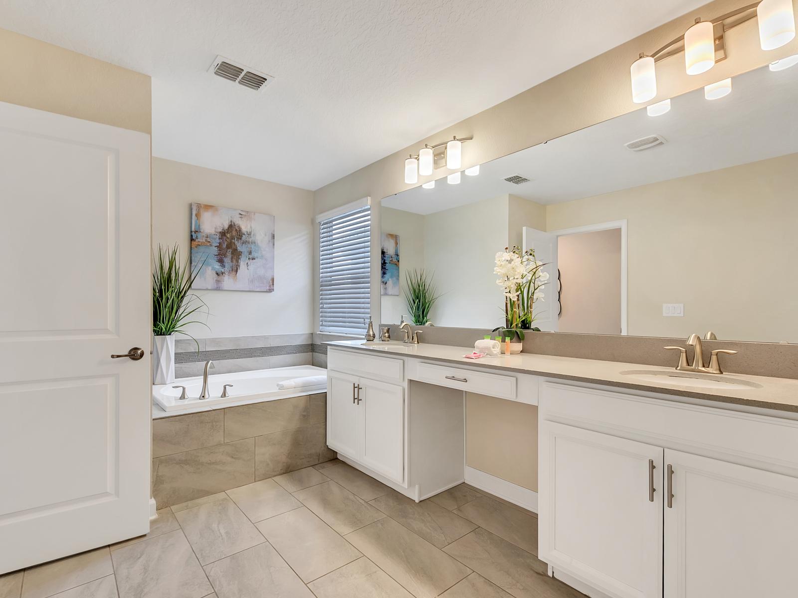 Lavish Bathroom of the Home in Davenport Florida - Chic design featuring a sleek vanity and upscale lighting - Well-lit space with strategically placed mirrors for a spacious feel