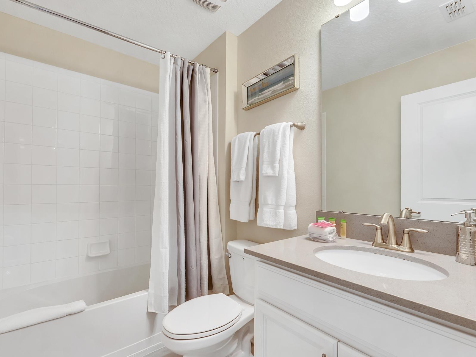 Lush Bathroom of the Home in Davenport Florida - Featuring both a shower and bathtub for your bathing pleasure - Chic Vanity with large mirror