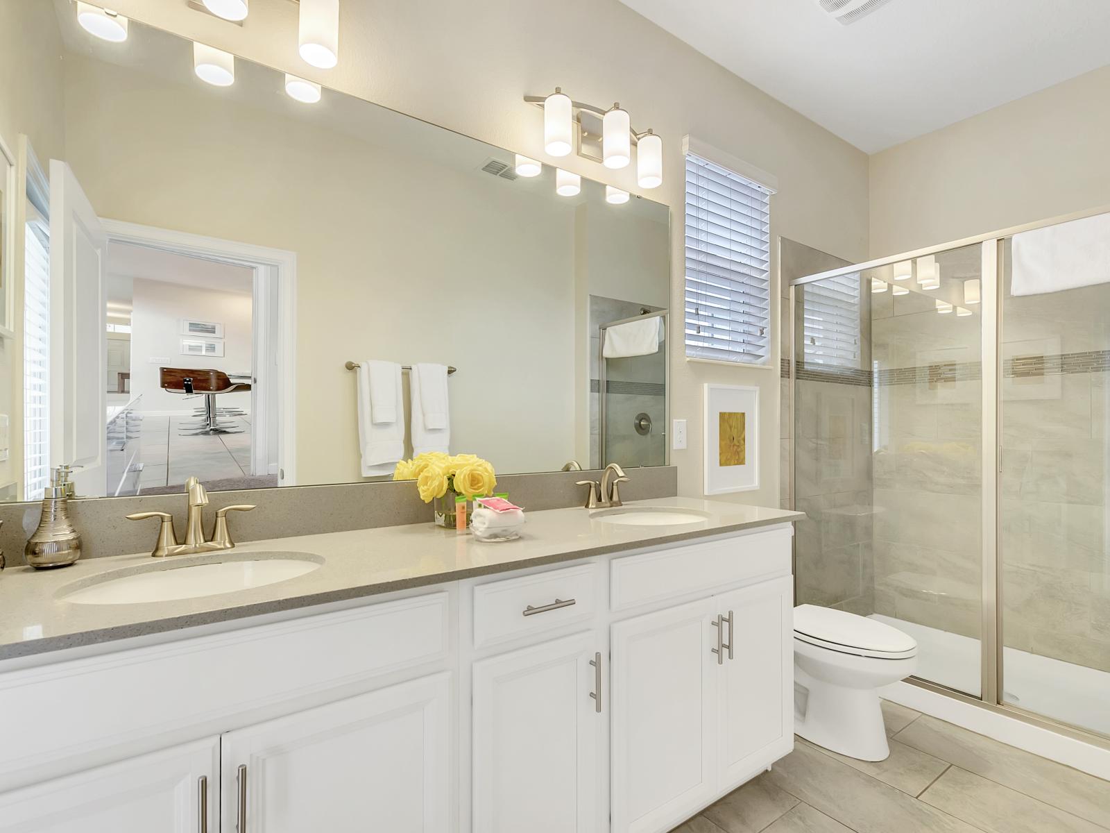 Lavish Bathroom of the Home in Davenport Florida - Great lighting - Beautiful Vanity with large size wall mirror - Availability of all Bathroom amenities - Separate glass-enclosed Shower area