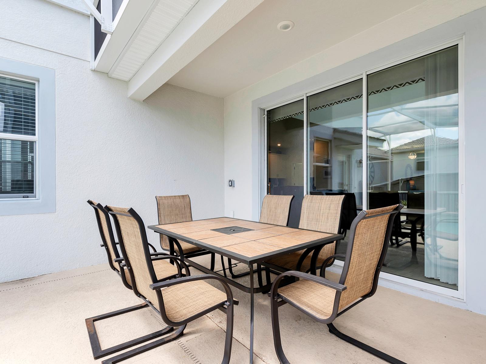 Posh Outdoor Dining Area of the Home in Davenport Florida - Dine in luxury and comfort with a view that steals the show  - Dining area overlooking the outside pool is a feast for the eyes - 6 Persons Dining