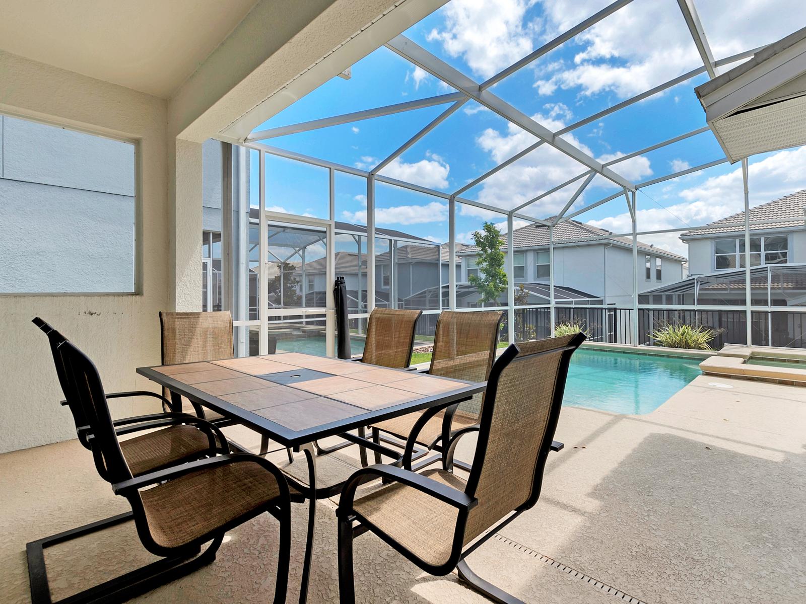 Lush Outdoor Dining Area of the Home in Davenport Florida - 6 Persons Dining - Outside dining table by the pool - Adapt experience for brunch, lunch, or dinner - Lush atmosphere