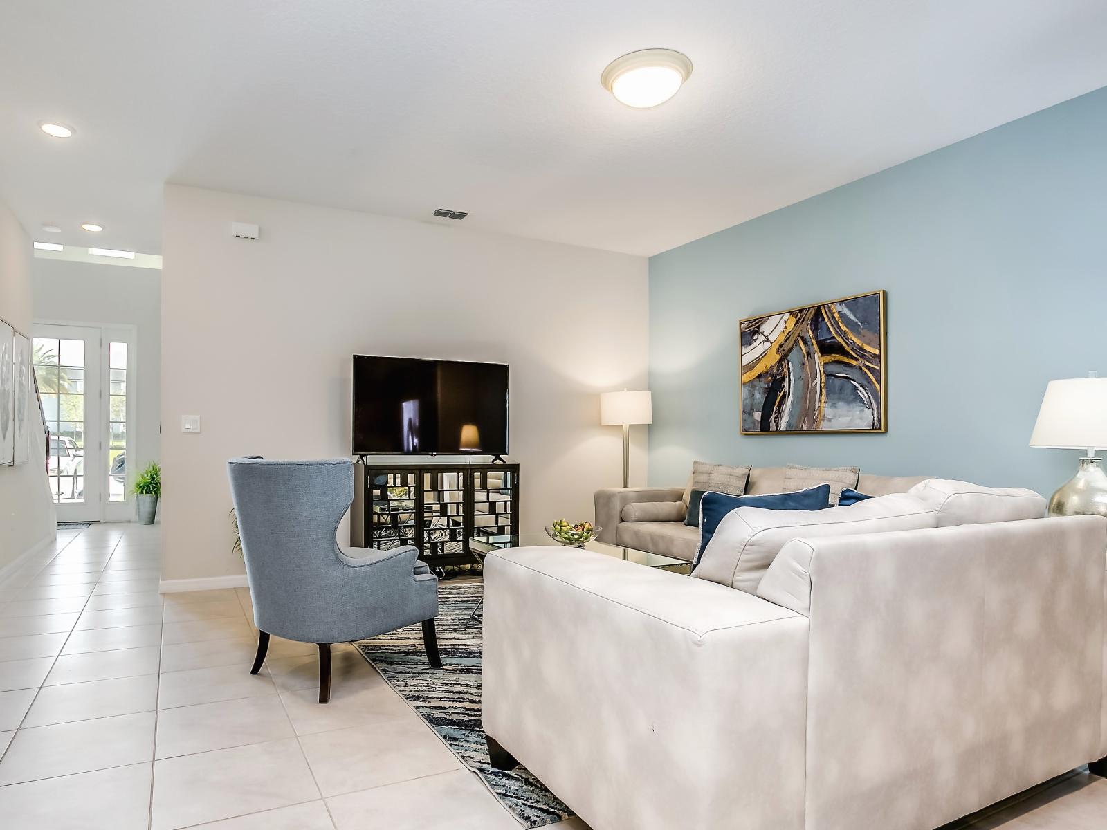 Relax and unwind in our cozy living room, complete with a comfortable couch and entertainment center featuring a sleek TV, where you can enjoy your favorite shows and movies in style.