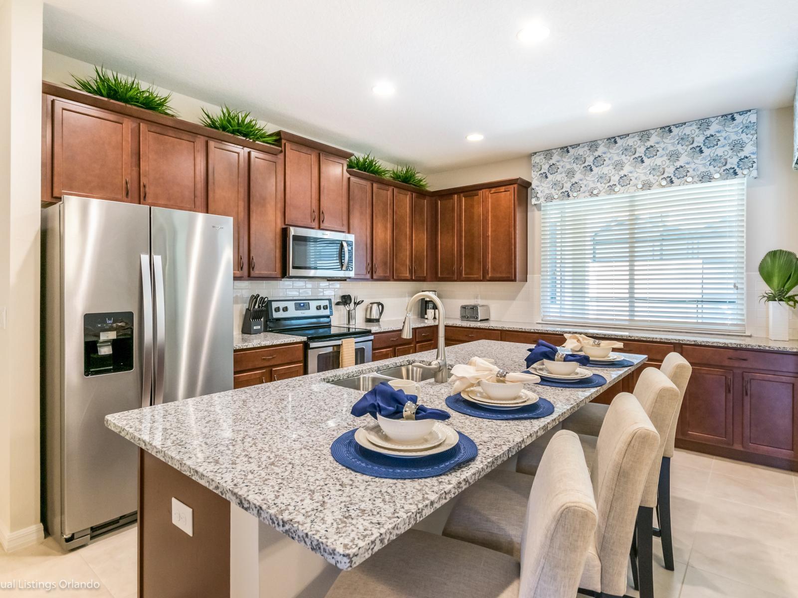 Polished kitchen of the townhouse in Kissimmee Florida - Fully equipped - Where culinary dreams come to life amidst modern amenities - Modern kitchen with sleek, stainless steel appliances