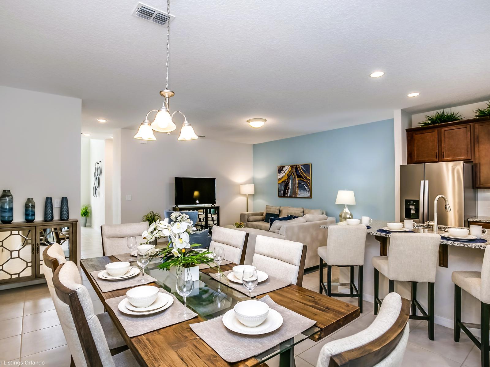 Chic dining area of the townhouse in Kissimmee Florida - Sophisticated design with a blend of modern and classic elements - Open layout seamlessly connecting the dining area to the kitchen and living area - Dining for 6 persons