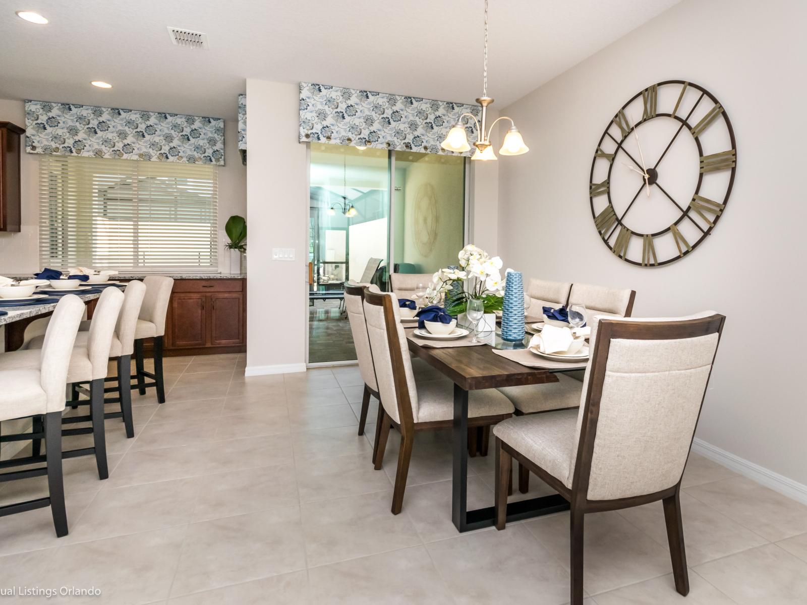 Alluring Dining Area of the townhouse in Kissimmee Florida - Quality materials, such as a sleek dining table and comfortable chairs - Sophisticated design with a blend of modern and classic elements - Intimate ambiance created through soft lighting