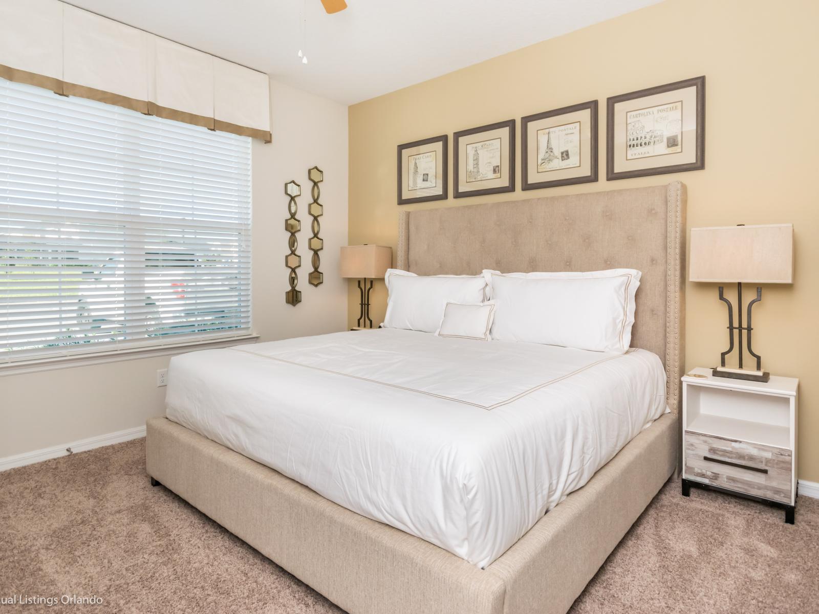 Elegant bedroom of the townhouse in Kissimmee Florida  - A plush double bed awaits - It offers convenience and relaxation - Providing with a restful haven to recharge and rejuvenate - Beautifully decored