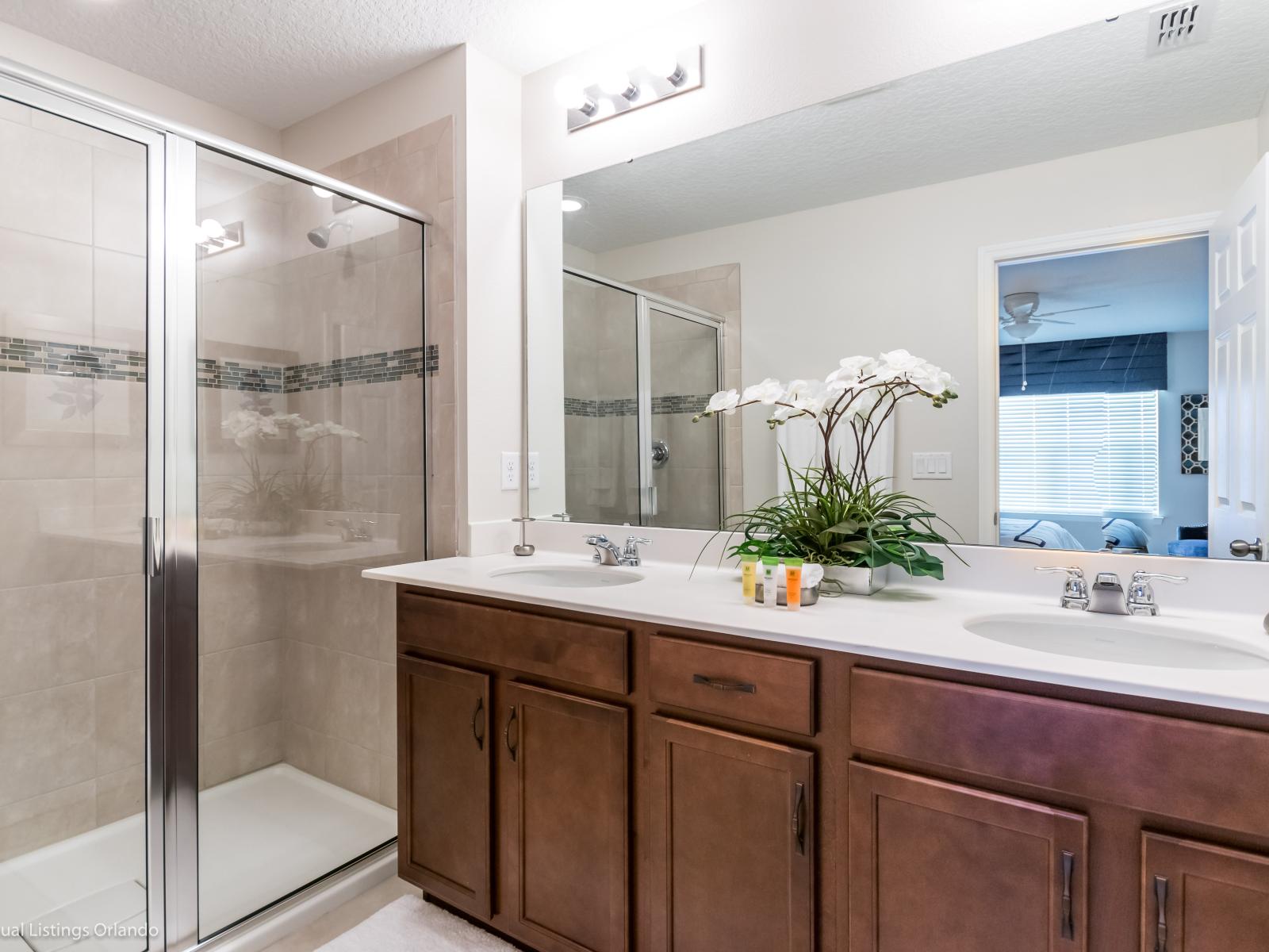 Lush bathroom  of the townhouse in Kissimmee Florida - Featuring a spacious walk-in shower - It's designed to offer a rejuvenating experience - Every shower feels like a refreshing escape from the ordinary