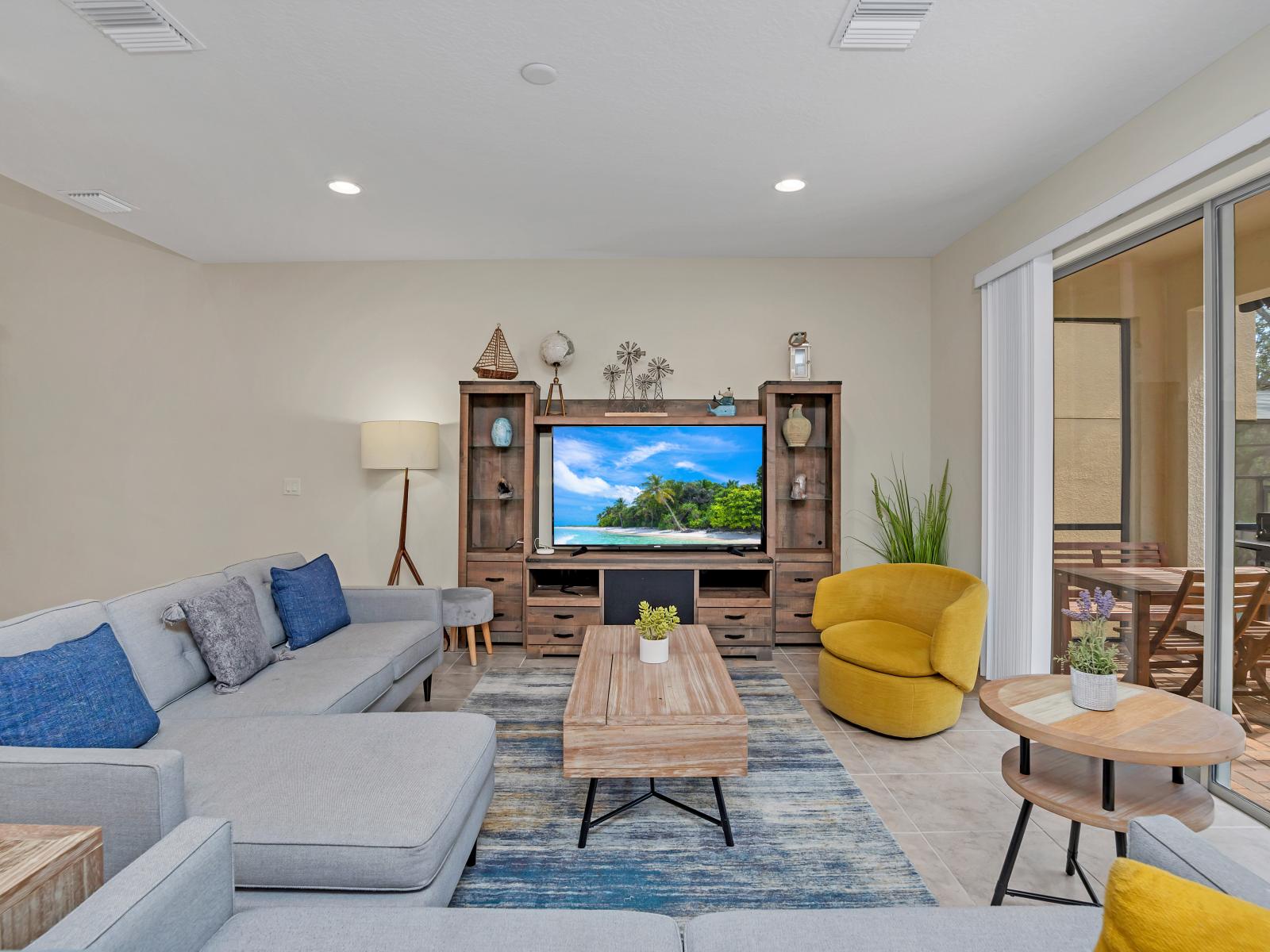 This living room offers a tranquil retreat, with expansive windows overlooking a private splash pool, where relaxation meets sophistication in perfect harmony.