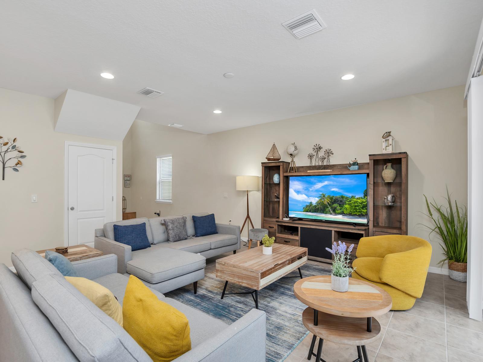 The living room, complete with a sleek TV setup, invites you to unwind and immerse yourself in your favorite shows and movies, creating cherished moments of relaxation and enjoyment.