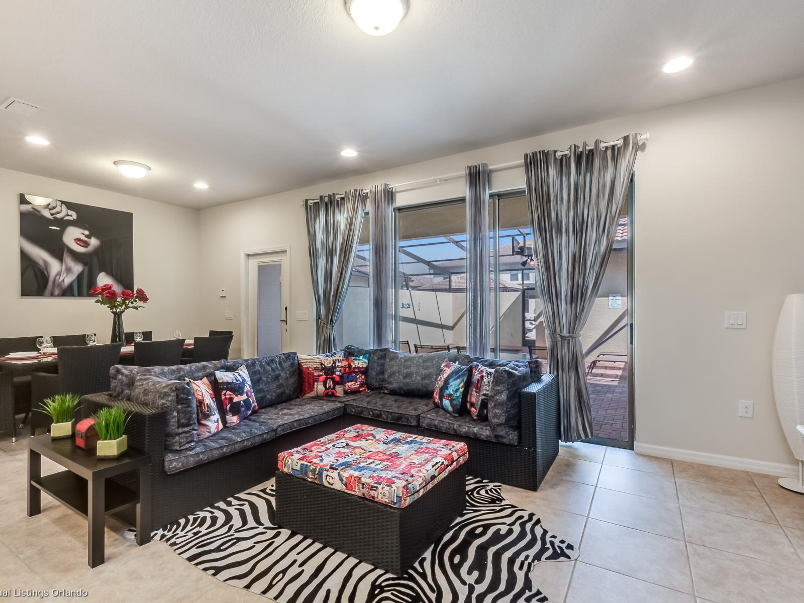 Sophisticated living area of the apartment in Kissimmee - Cosy sofas - Elegantly decored living area - Large bright windows of the living area with Mesmerizing views - Beautifully tile furnished floor - Availability of TV and Netflix