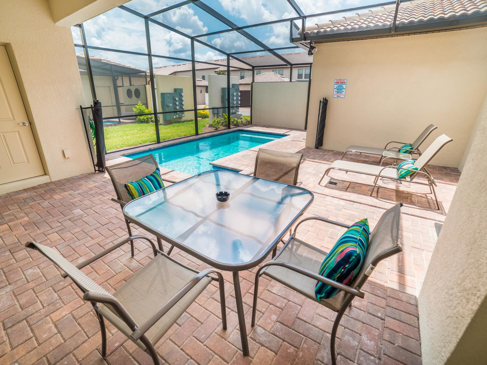 Attractive private pool of the Townhouse in Kissimmee Florida - Perfect for unwinding and soaking in the beauty of the outdoors. - Dive into luxury with glass-covered pool, offering the unique experience of swimming under the sky