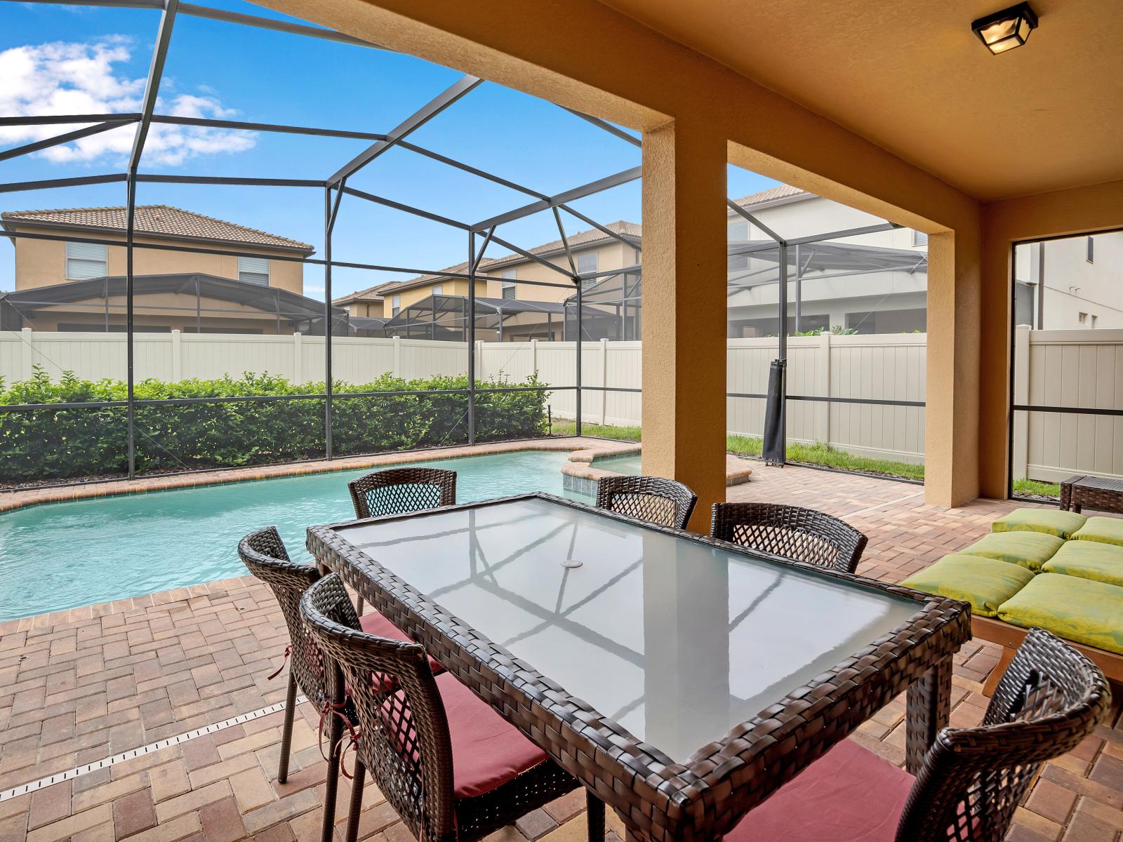 Escape to your oasis: Enjoy the ultimate in outdoor living on our private screened-in lanai, complete with a patio table, lounge chairs, and a refreshing pool.