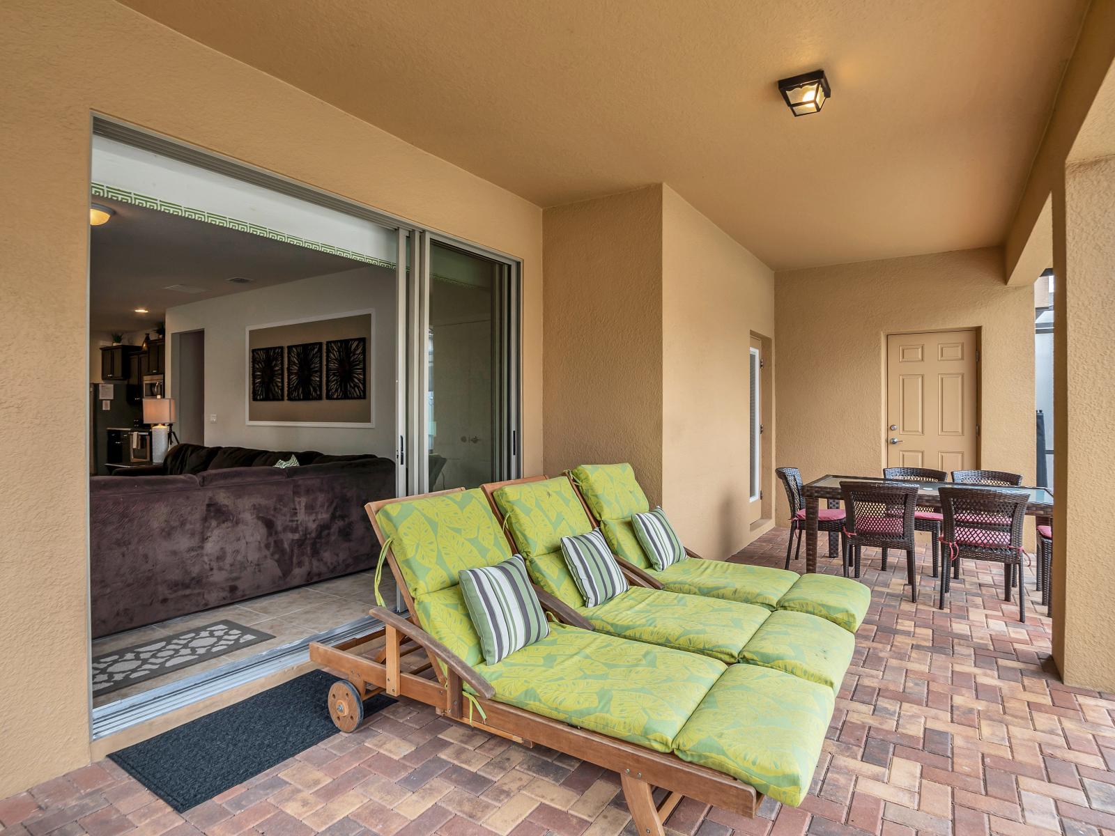 Your private retreat awaits: Step onto our screened-in lanai featuring a patio table, cozy lounge chairs, and a tranquil pool.