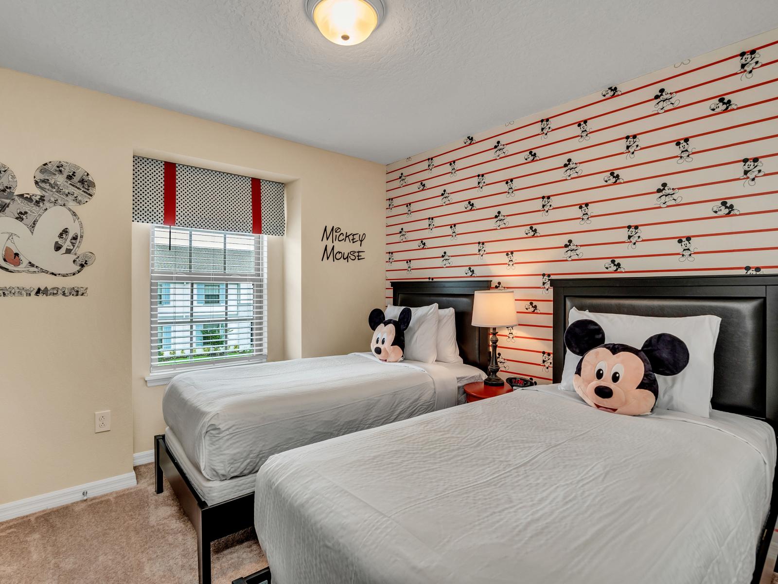 Mickey themed kids room with 2 single beds