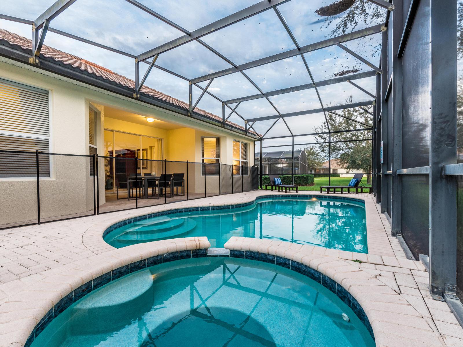 Private pool of the home in Kissimmee, Florida - Experience exceptional privacy while swimming in your exclusive glass-covered pool - Elevate your dining experience with poolside dining table, perfect for unwinding under the sun or stars