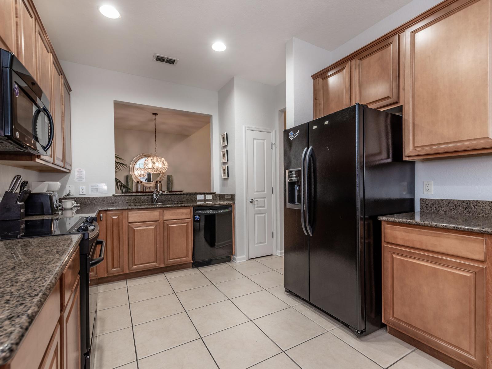 Charming kitchen of the home in Kissimmee, Florida - Fully Equipped  kitchen with sleek, stainless-steel appliances - Plenty of storage space available to keep counters organized