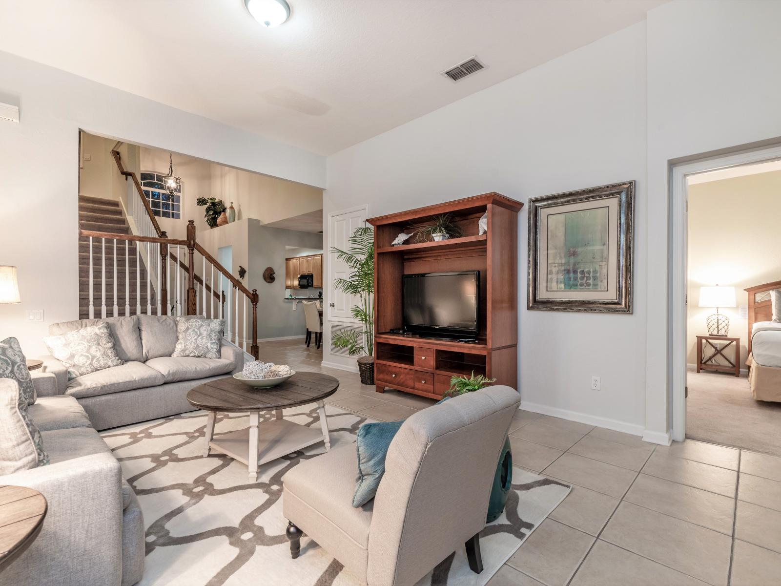 Spacious living area of the home in Kissimmee, Florida - This elegant living area creating the perfect space for relaxation and socializing - Comfortable sofa seating with modern design rug on floor -  Smart TV for the entertainment