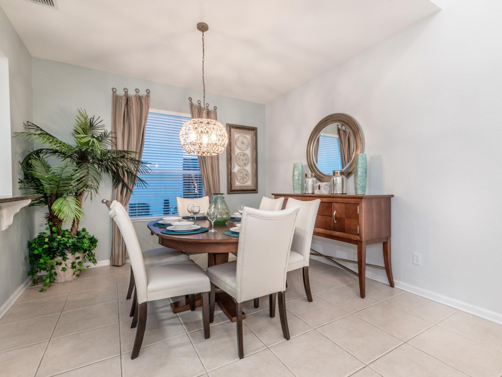 Classy 6 persons dining area of the home in Kissimmee, Florida - Savor the experience of exquisite dining and treasured moments - Smooth incorporation of natural elements, such as plants, for a fresh and vibrant atmosphere