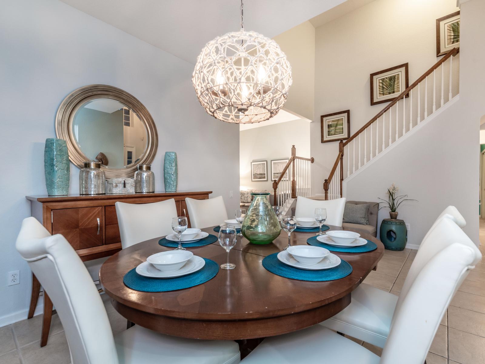 Classy 6 persons dining area of the home in Kissimmee, Florida - Savor the experience of exquisite dining and treasured moments - Smooth incorporation of natural elements, such as plants, for a fresh and vibrant atmosphere