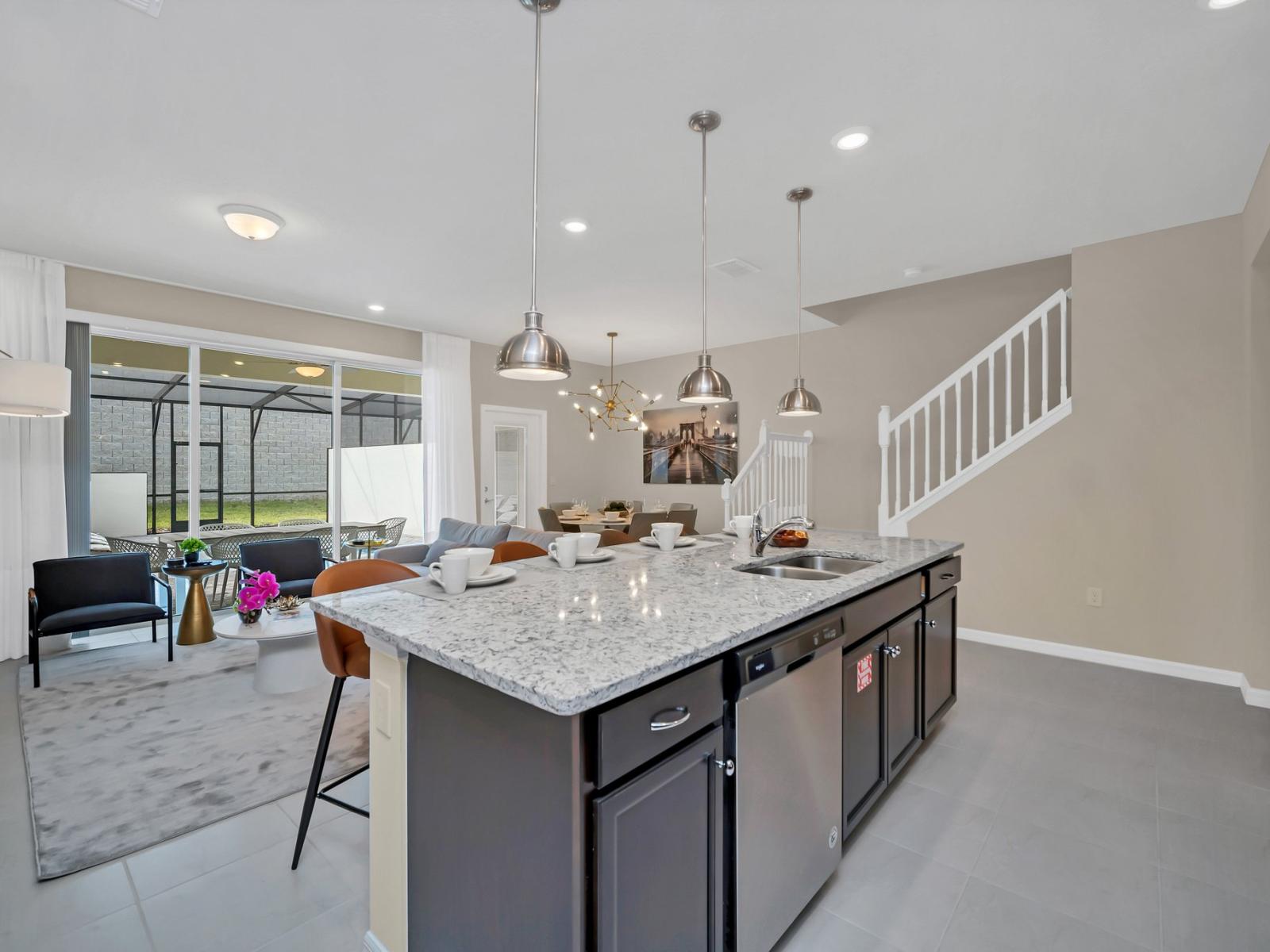 Contemporary open concept Kitchen with countertop and high chairs for a quick coffee or snack fronting the living room