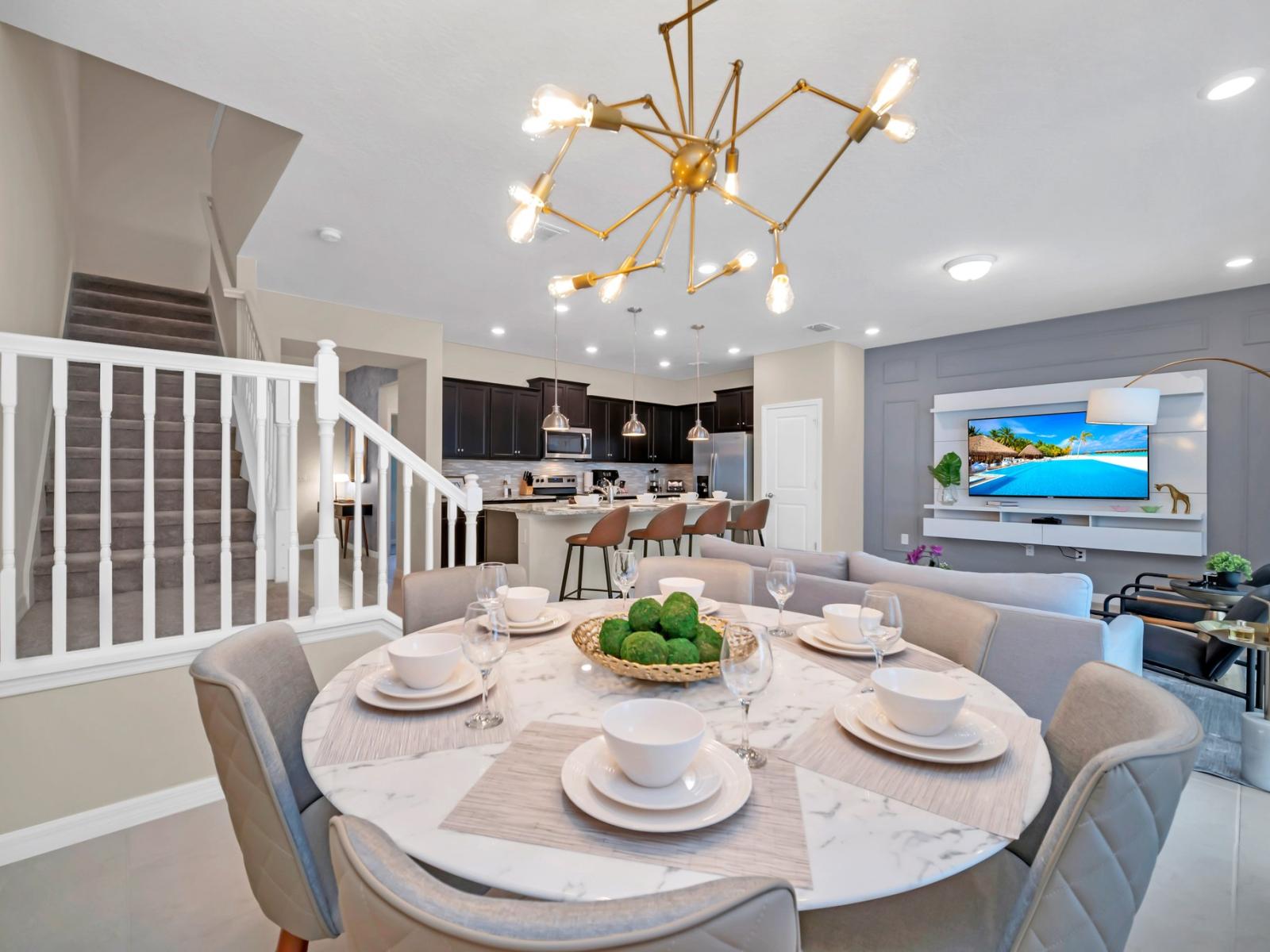 Luxurious open concept kitchen and dining area of the townhouse in Polk County, Florida - Fully stocked kitchen ready for culinary adventures - Seating for six in the dining area - Opulent finishes and impeccable craftsmanship