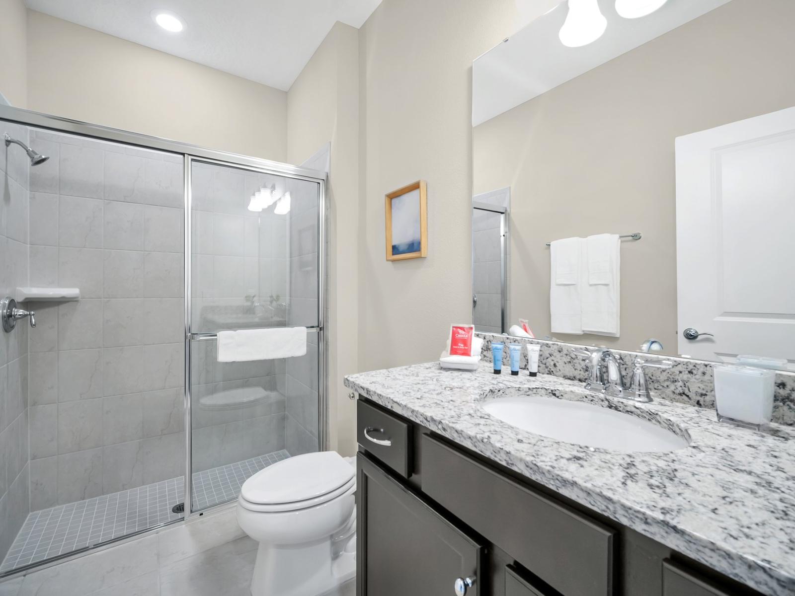 Lush Bathroom of the townhouse in Polk County, Florida - Turn your shower into a radiant haven with a modern glass-enclosed sanctuary - Chic vanity featuring a spacious mirror and plenty of storage - All bathroom essentials readily available