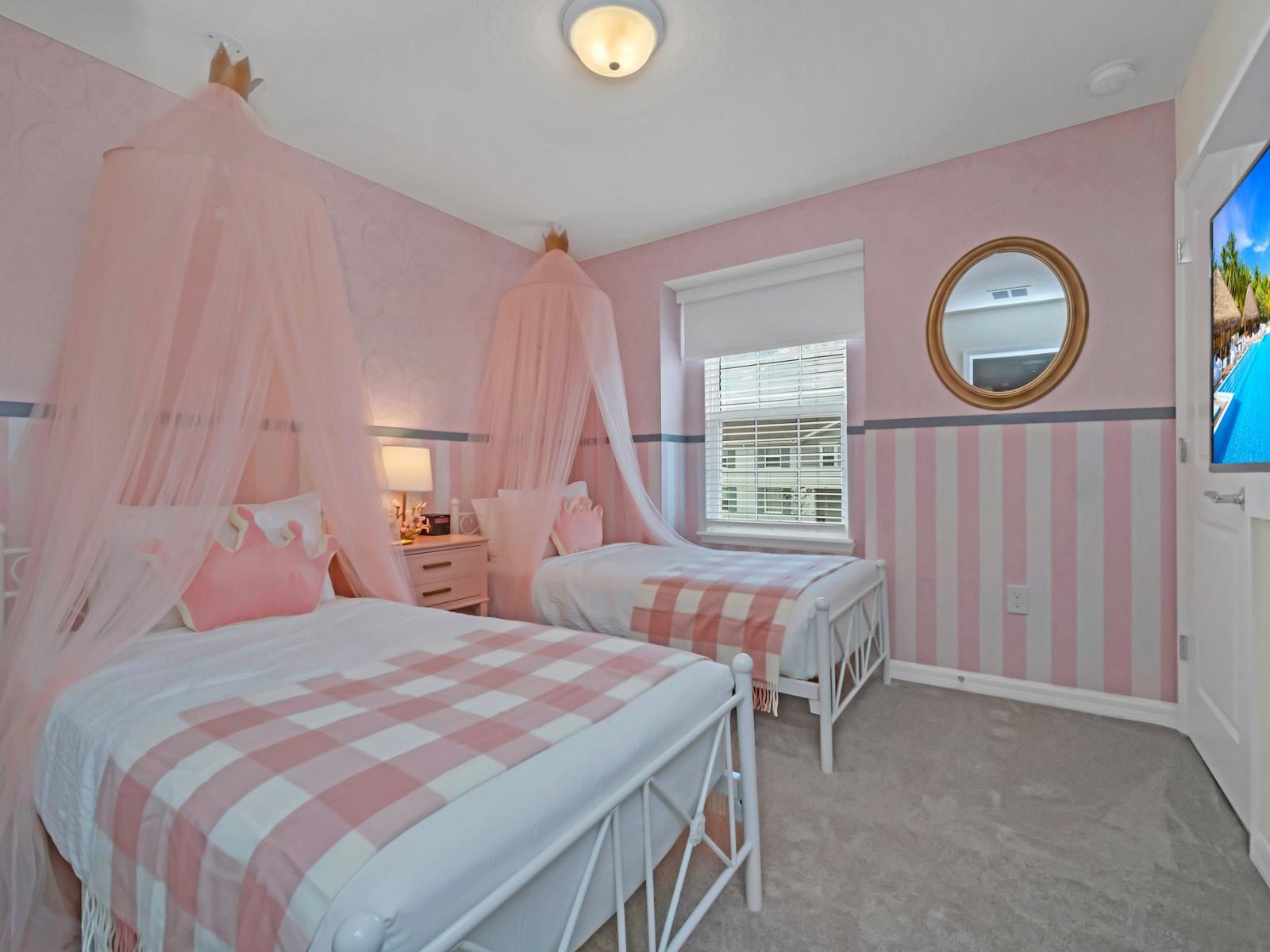 Enchanting kids' room of the townhouse in Polk County, Florida - two single beds with comfy bedding and soft pillows - Abundant space for tidily storing your prized possessions - Smart TV for kids entertainment