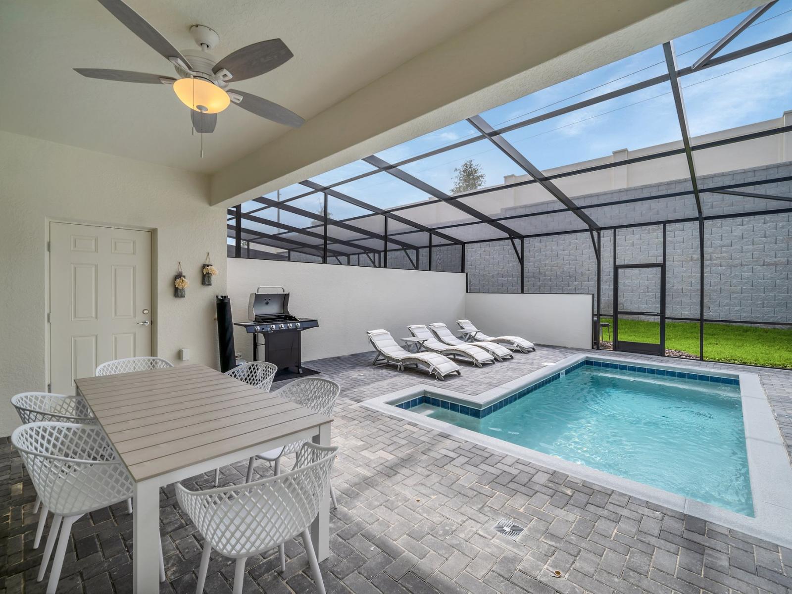 Paradise found: Experience ultimate relaxation with a splash pool, loungers, and grill on our screened-in lanai.