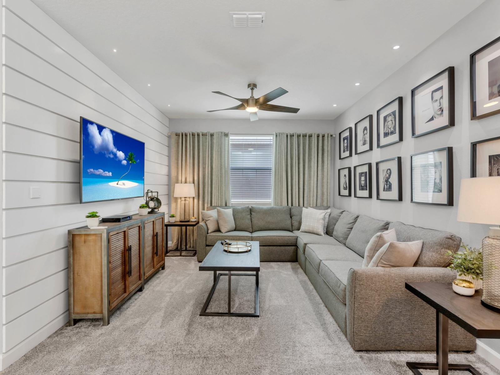 Elegant living area of the home in Kissimmee Florida - Thoughtfully decored space with a neutral color palette for a timeless appeal - Cozy seating area conducive to relaxation and socializing - Smart TV for entertainment