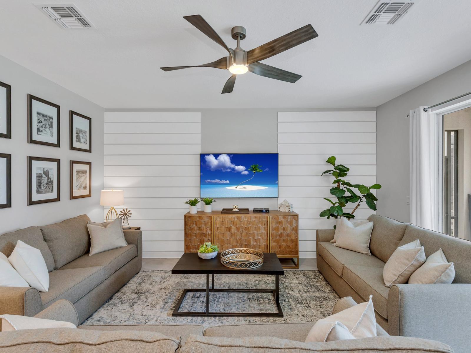 Bright living area of the home in Kissimmee Florida - Chic furnishings and contemporary decor accents - Sumptuous seating options ideal for relaxation and conversation - Tranquil surroundings with serene views of the outdoors