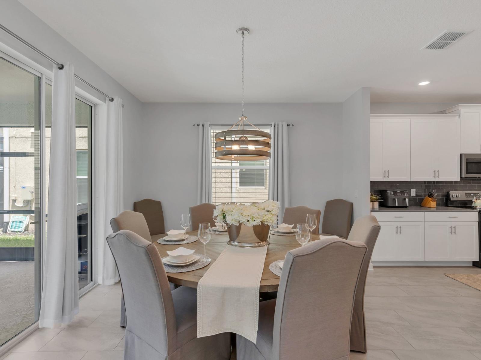 Sleek dining area of the home in Kissimmee Florida - 6 persons dining table - Thoughtful lighting fixtures creating an intimate and inviting atmosphere - Harmonious color scheme for a cohesive and stylish look