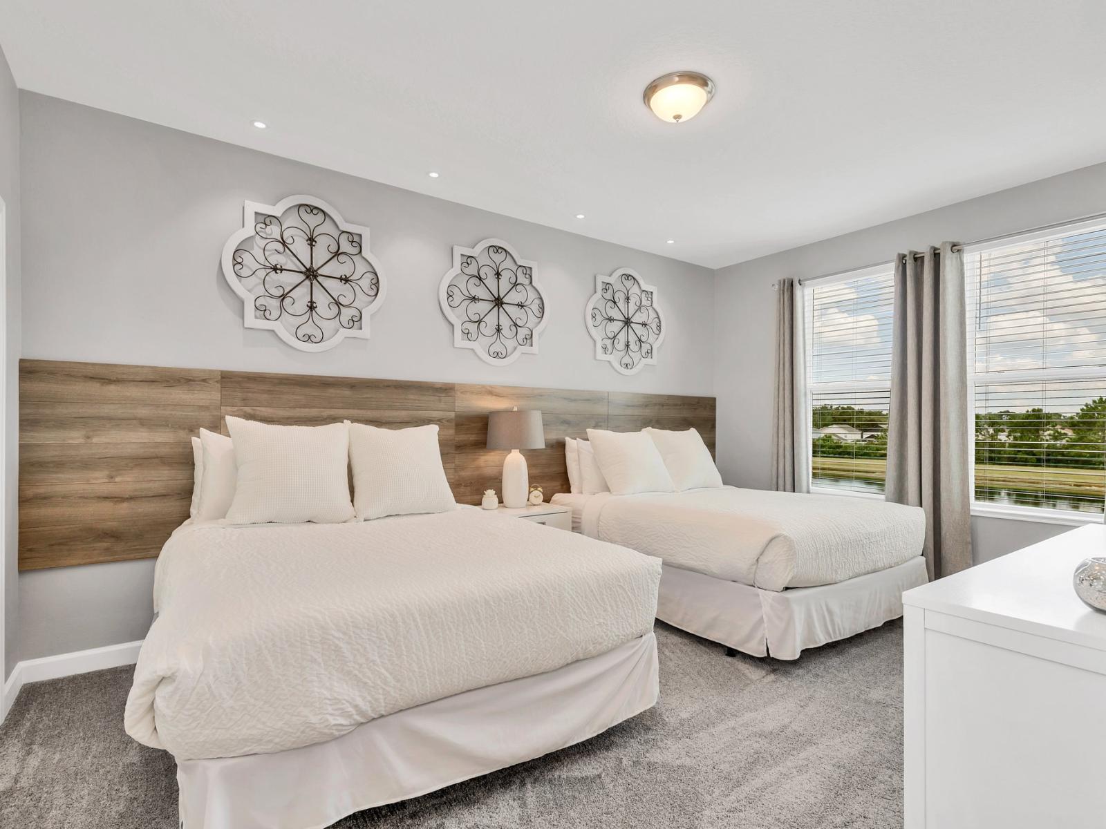 Comfy bedroom of the home in Kissimmee Florida - Featuring two double beds - Well-appointed bedroom with neutral tones for a calming atmosphere - Smart TV and Netflix