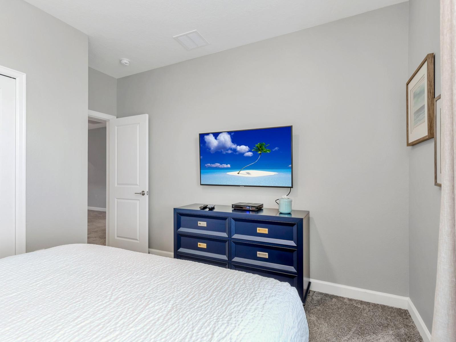 Urban Elegance: Unwind in style in our townhouse bedroom, where modern design meets convenience with a sleek Smart TV for a sophisticated stay.