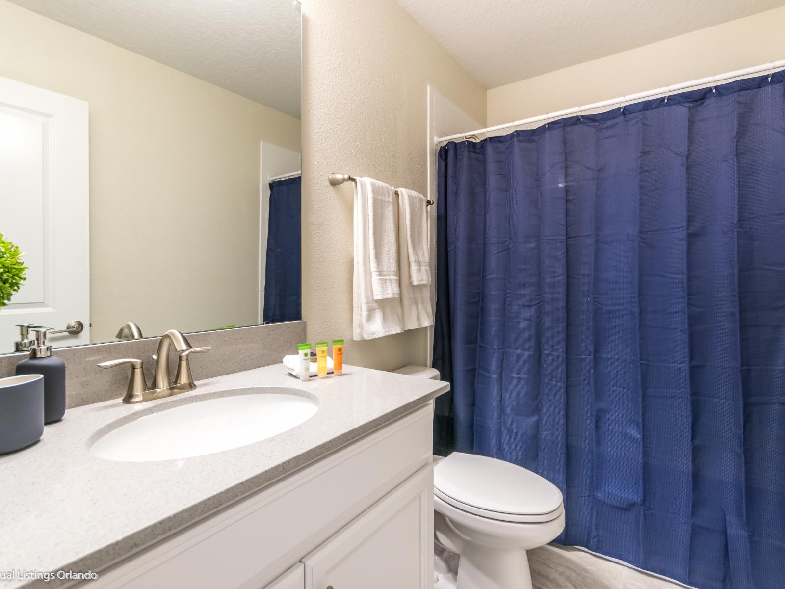 What could be better than a warm, comforting shower in this spotless bathroom with elegant bathtub with overhead shower.