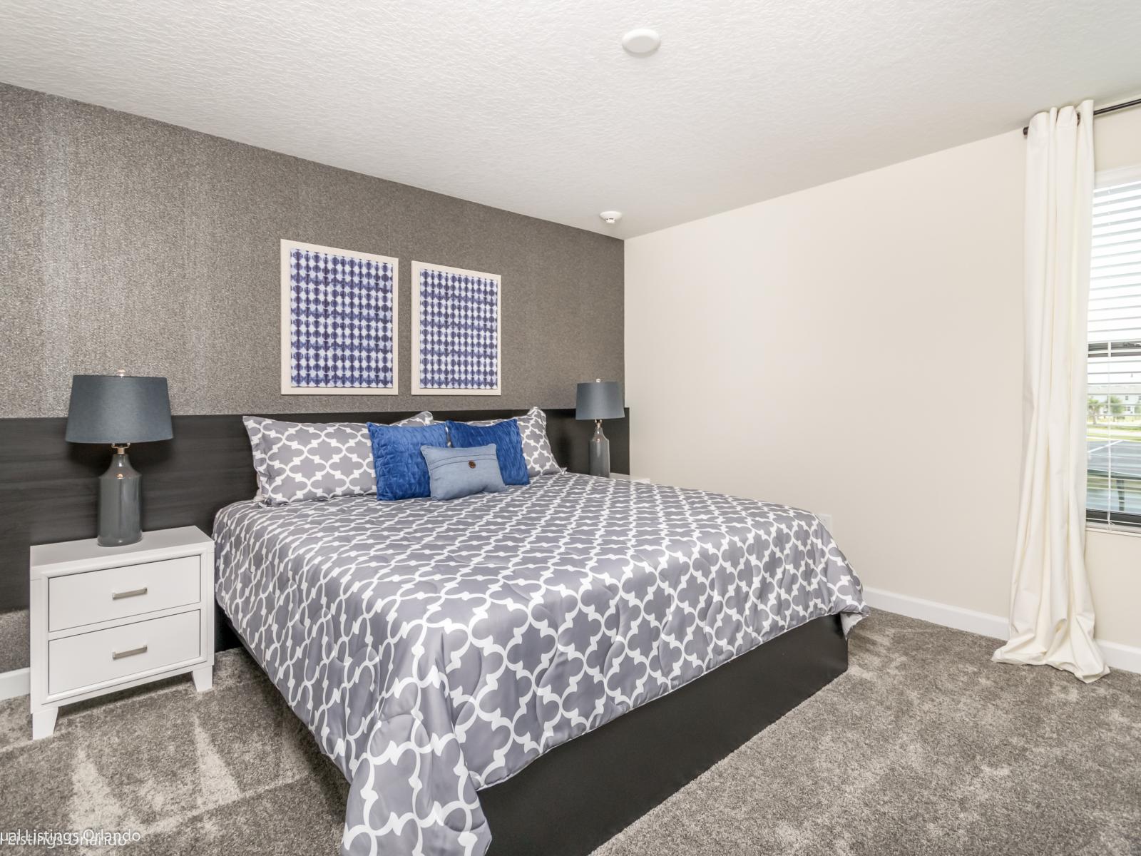 Plush bedroom of the home in Kissimmee Florida - Stylish furnishings for a modern and elegant look - Cozy double bed - Seamless blend of comfort, aesthetics, and functionality