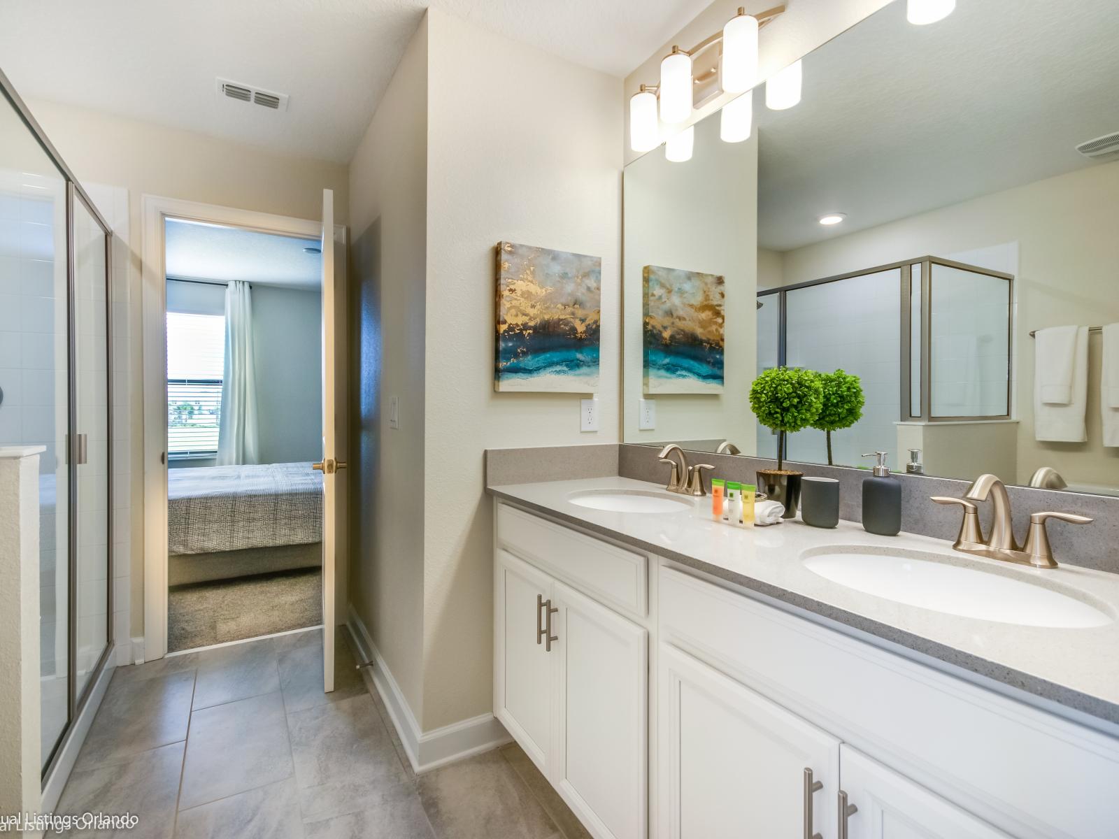 Unwind in our tranquil bathroom oasis, where minimalist design meets ultimate relaxation with a sleek walk-in shower area and calming earth tones.