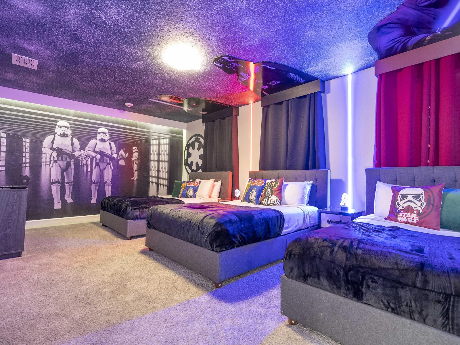 Star Wars themed bedroom of the home in Kissimmee Florida - Spacious bedroom offering comfort and style - Plenty of sleeping space with three double beds - Thoughtfully designed bedroom featuring functional and stylish furniture