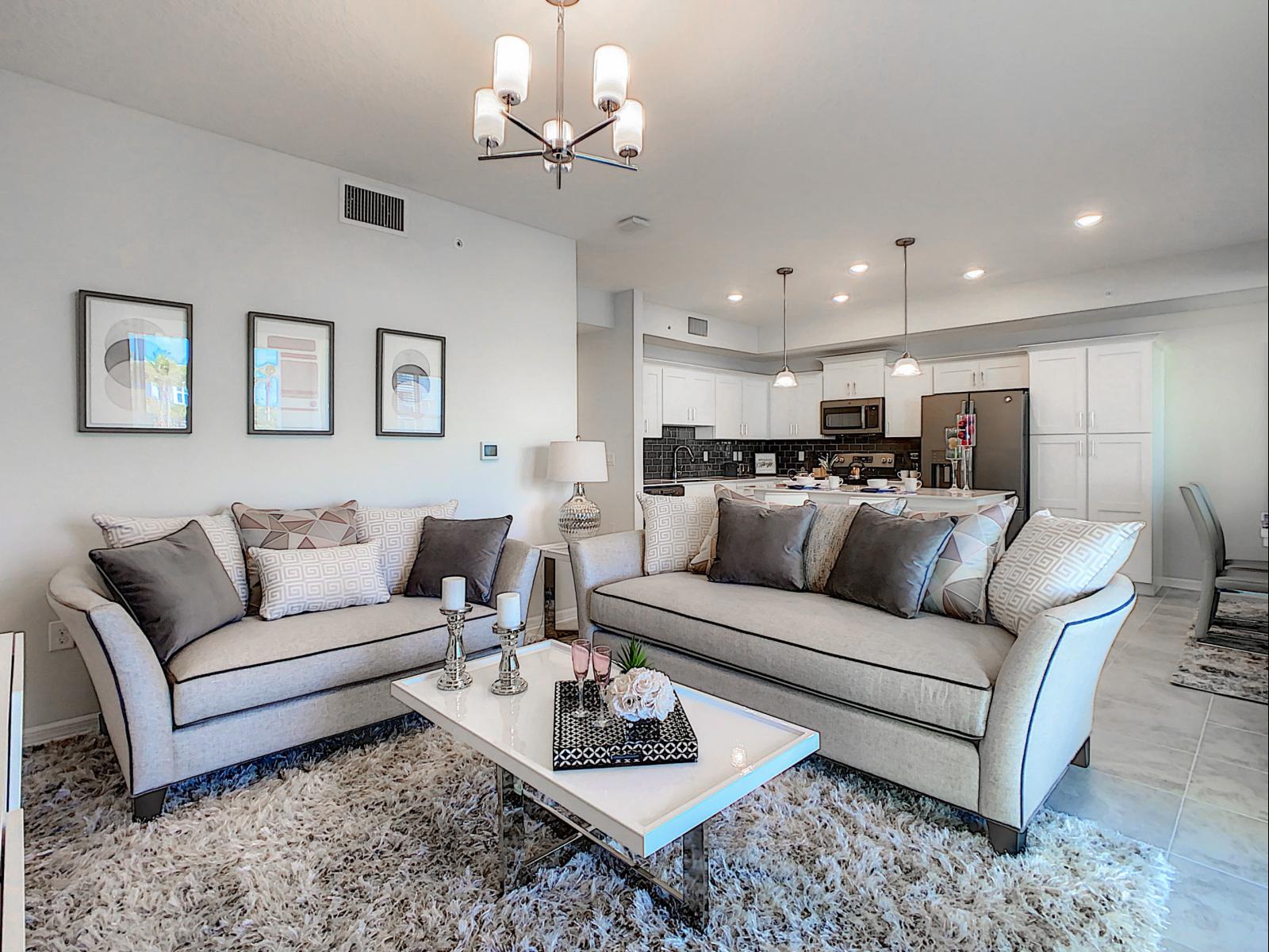 Beautifully designed lounge with soft,  plush sofas that invite you to sink in - Open layout seamlessly connects to the kitchen, making it great for entertaining - Elegant decor and a neutral palette bring a sophisticated charm to this living space