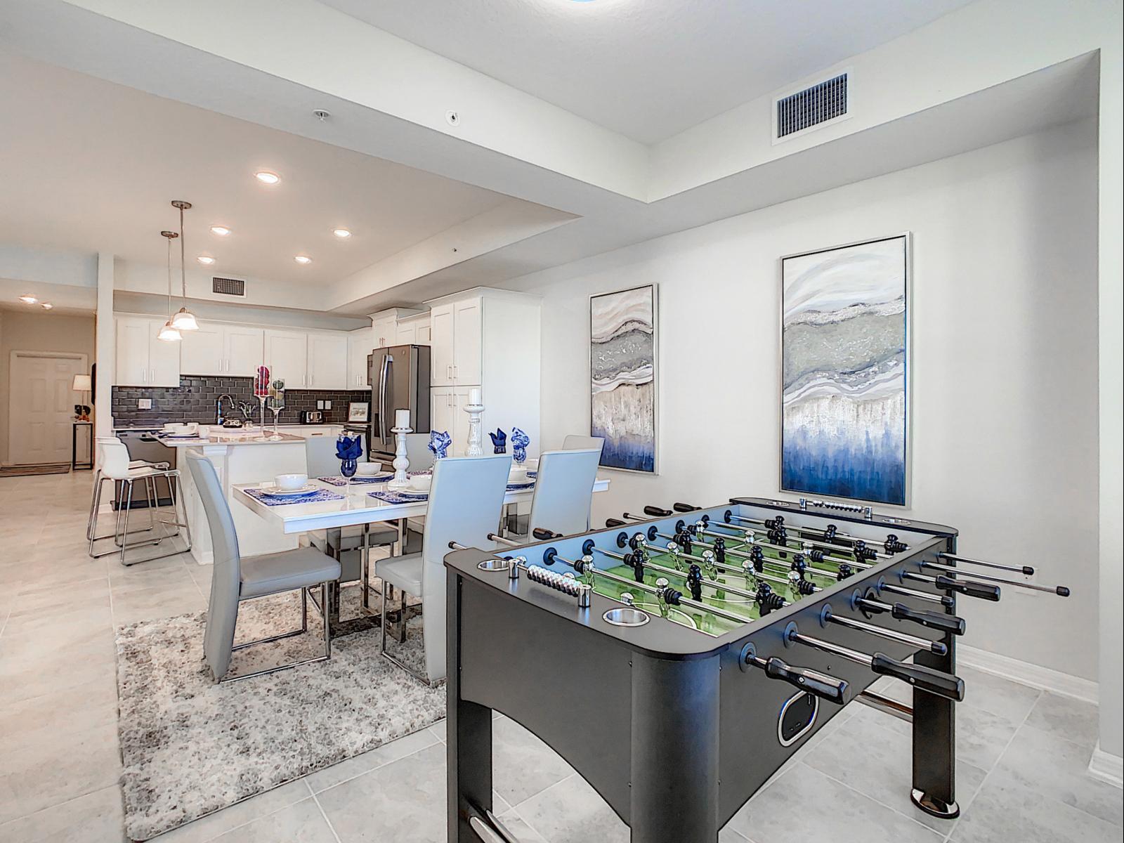 Fun meets functionality with a foosball table at the center of this inviting, open layout - Enjoy a game night or a cozy dinner, all in one stylish and spacious setting - Bright, airy, and perfect for family gatherings or friendly competition