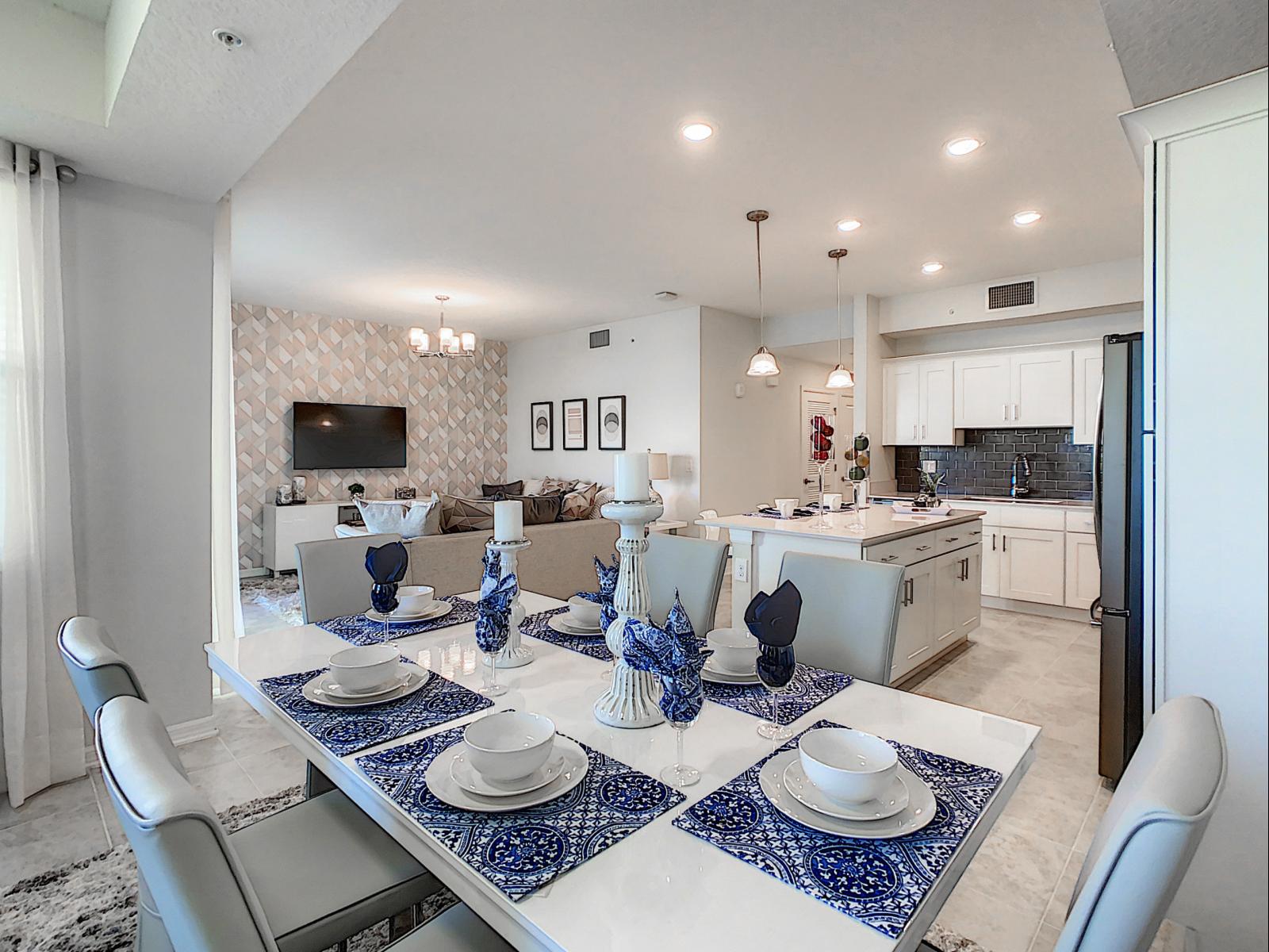 Open-concept dining area seamlessly flows into the kitchen and living room - Blue and white decor adds a refreshing coastal feel, making every meal a relaxing experience - Cozy yet chic setup for dinners, conversations, and everything in between