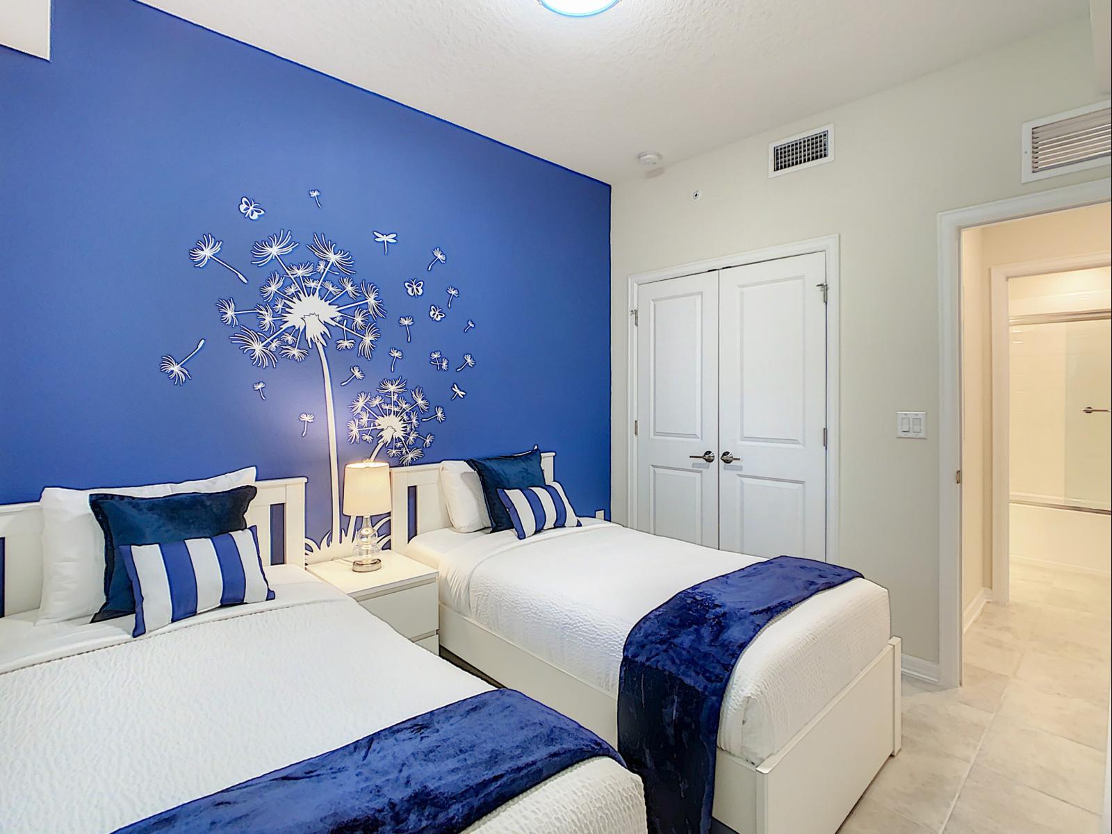 Lively blue-themed bedroom is all about comfort and style, perfect for unwinding - Dandelion decal and cozy accents make space feel like a modern-day fairy tale - Inviting and full of personality, a room designed for sweet dreams and happy vibes